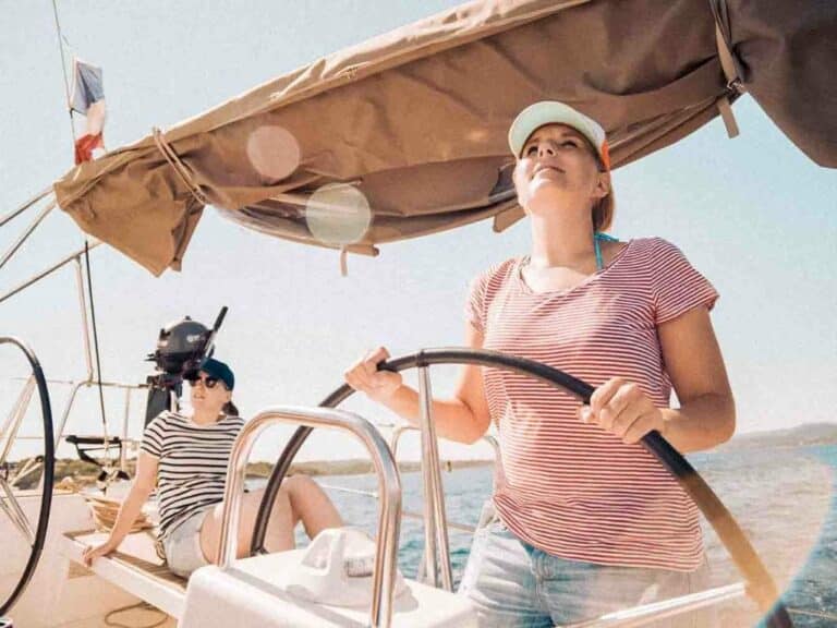 Woman at the helm of a sailing yacht in France